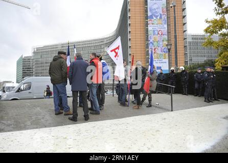 (141211) -- BRUSSELS, Dec. 11, 2014 -- Photo taken on Dec. 11, 2014 shows European dairy farmers standing next to policemen as dumping milk flowing on the ground in front of the European Commission headquarters duing a protest against low selling prices in Brussels, capital of Belgium. ) BELGIUM-BRUSSELS-EU-DAIRY FARMER-PROTEST YexPingfan PUBLICATIONxNOTxINxCHN   Brussels DEC 11 2014 Photo Taken ON DEC 11 2014 Shows European Dairy Farmers thing Next to Policemen As Dumping Milk Flowing ON The Ground in Front of The European Commission Headquarters dunebarchan Langen a Protest against Low Selli Stock Photo