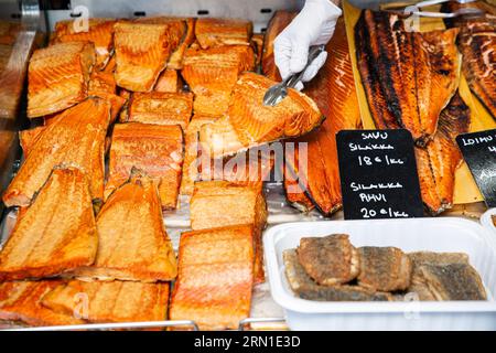Appetizing fried fish at a food market in Finland. Various smoked fish products. Stock Photo