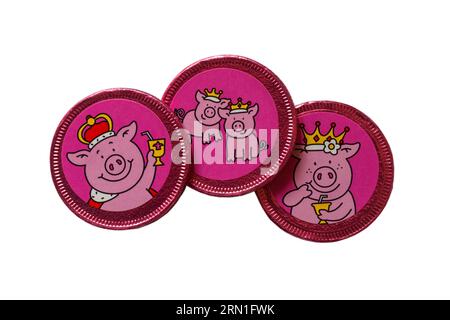 Percy Pig pennies fruit flavoured chocolate pennies from M&S isolated on white background - foil wrapped chocolate penny Stock Photo