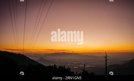 A sunny morning shines through the tops through a thin layer of mist, creating beautiful railway tracks, Dalat landscape, Dalat suburban landscape, Vietnamese landscape Stock Photo