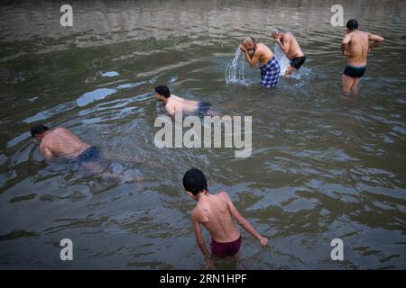 Kathmandu, Nepal. 31st Aug, 2023. Hindu devotees take a holy bath while performing rituals at Gokarneshor, Uttarbahini temple during the Janai Purnima festival. Janai Purnima also known as the Sacred Thread festival or Rakshya Bandhan festival, Hindu men, especially the Brahmans and Chettris, perform their annual change of Janai, sacred threads worn across the chest or tied around the wrist and Purified by mantras. The thread is a symbol of protection. Credit: SOPA Images Limited/Alamy Live News Stock Photo