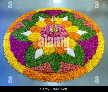Pookalam, celebrated during Onam festival, a lively tradition in Kerala, features intricate, colorful flower arrangements on the floor. Stock Photo