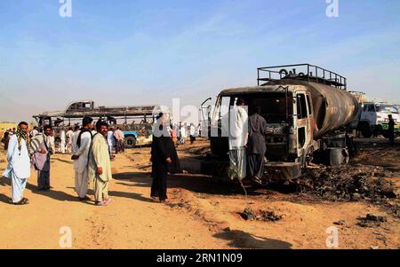 (150111) -- KARACHI, Jan. 11, 2015 -- Pakistani people examine a burnt passenger bus and oil tanker at the accident site near southern Pakistani port city of Karachi on Jan. 11, 2015. At least 59 people were killed and four others injured when a passenger bus hit an oil tanker in Pakistan s southern port city of Karachi on early Sunday morning, hospital sources said. ) PAKISTAN-KARACHI-ACCIDENT-DEATH-TOLL Arshad PUBLICATIONxNOTxINxCHN   Karachi Jan 11 2015 Pakistani Celebrities examine a Burnt Passenger Bus and Oil Tankers AT The accident Site Near Southern Pakistani Port City of Karachi ON Ja Stock Photo