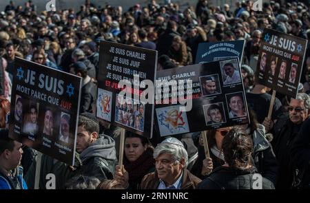 (150113) -- JERUSALEM, Jan. 13, 2015 -- People hold placards during a funeral ceremony for the four victims of Paris supermarket attack at Givat Shaul cemetery, on the outskirts of Jerusalem, on Jan. 13, 2015. Israeli leaders and multitude of mourners gathered Tuesday with the families of four Jewish victims of last week s terror attack on a Paris kosher supermarket for a solemn funeral ceremony at a Jerusalem cemetery. Yoav Hattab, Yohan Cohen, Philippe Braham and Francois-Michel Saada, were gunned down on Friday during a hostage attack on Hyper Casher supermarket in eastern Paris. They were Stock Photo