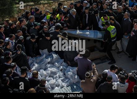 (150113) -- JERUSALEM, Jan. 13, 2015 -- A body of victim of Paris supermarket attack is carried to the grave during a funeral ceremony at Givat Shaul cemetery, on the outskirts of Jerusalem, on Jan. 13, 2015. Israeli leaders and multitude of mourners gathered Tuesday with the families of four Jewish victims of last week s terror attack on a Paris kosher supermarket for a solemn funeral ceremony at a Jerusalem cemetery. Yoav Hattab, Yohan Cohen, Philippe Braham and Francois-Michel Saada, were gunned down on Friday during a hostage attack on Hyper Casher supermarket in eastern Paris. They were a Stock Photo