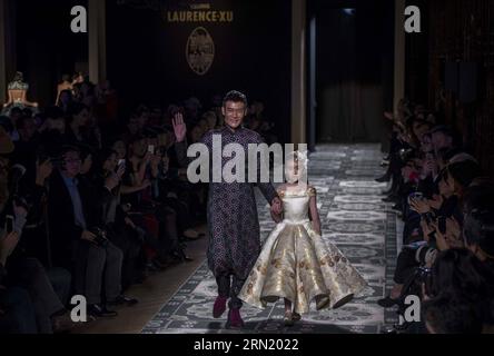 Chinese fashion designer Laurence Xu (L) acknowledges the audience at the end of his 2015 Haute Couture Spring-Summer collection fashion show in Paris, France, Jan. 27, 2015. ) FRANCE-PARIS-FASHION WEEK-LAURENCE XU ChenxXiaowei PUBLICATIONxNOTxINxCHN   Chinese Fashion Designers Laurence Xu l  The audience AT The End of His 2015 Haute Couture Spring Summer Collection Fashion Show in Paris France Jan 27 2015 France Paris Fashion Week Laurence Xu  PUBLICATIONxNOTxINxCHN Stock Photo