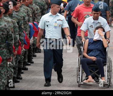 (150129) -- PASAY CITY, Jan. 29, 2015 -- A pregnant relative of one of the fallen Philippine National Police Special Action Force (PNP-SAF) members sits in a wheelchair after fainting at the Villamor Air Base in Pasay City, the Philippines, Jan. 29, 2015. Forty-four members of the PNP-SAF were killed allegedly by Moro Islamic Liberation Front and Bangsamoro Islamic Freedom Fighters members on Jan. 25 in Mamasapano, Maguindanao. ) PHILIPPINES-PASAY CITY-POLICE RouellexUmali PUBLICATIONxNOTxINxCHN   Pasay City Jan 29 2015 a Pregnant relative of One of The Fall Philippine National Police Special Stock Photo