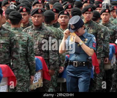 (150129) -- PASAY CITY, Jan. 29, 2015 -- A policewoman weeps as she walks past the caskets carrying the fallen members of the Philippine National Police Special Action Force (PNP-SAF) at the Villamor Air Base in Pasay City, the Philippines, Jan. 29, 2015. Forty-four members of the PNP-SAF were killed allegedly by Moro Islamic Liberation Front and Bangsamoro Islamic Freedom Fighters members on Jan. 25 in Mamasapano, Maguindanao. ) PHILIPPINES-PASAY CITY-POLICE RouellexUmali PUBLICATIONxNOTxINxCHN   Pasay City Jan 29 2015 a police woman  As She Walks Past The casket carrying The Fall Members of Stock Photo