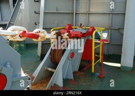 Close view on anchor roller chain stopper for hawse pipe on the forward mooring station of container vessel. Stock Photo