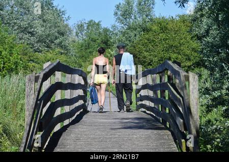 Clairmarais (northern France): two people having a walk in the Etangs du Romelaere National Nature Reserve, in the Caps et Marais d'Opale Regional Nat Stock Photo