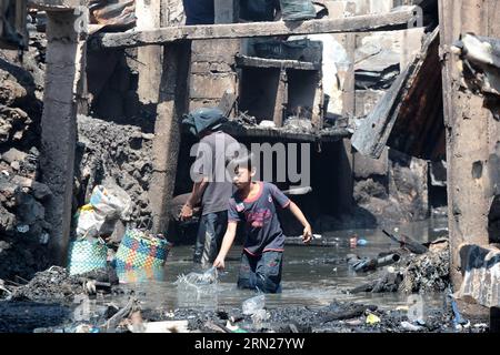 (150216) -- PASAY CITY, Feb. 16, 2015 -- Residents scavenge for their belongings from a creek after a fire at a slum area in Pasay City, the Philippines, Feb. 16, 2015. At least four people were killed after a fire razed about 300 houses made of light materials, local media reported. )(lyi) PHILIPPINES-PASAY CITY-FIRE RouellexUmali PUBLICATIONxNOTxINxCHN   Pasay City Feb 16 2015 Residents scavenge for their belonging from a Creek After a Fire AT a Slum Area in Pasay City The Philippines Feb 16 2015 AT least Four Celebrities Were KILLED After a Fire razed About 300 Houses Made of Light Material Stock Photo