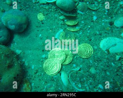 JERUSALEM, Feb. 17, 2015 -- An undated photograph supplied by the Israeli Antiquities Authority on Feb. 17, 2015 shows the largest hoard of gold coins ever found in Israel as they were discovered on the seabed in the ancient harbor of Caesarea National Park. A fortune of at least 2,000 ancient gold coins were discovered accidentally by scuba divers offshore Israel about two weeks ago, the said on Tuesday. It was found on the seabed in the ancient harbor of Caesarea National Park, the Antiquities Authority said in a statement. JINI/Hand Out/) ISRAEL-CAESAREA-ANCIENT GOLD COINS-DISCOVERY Israelx Stock Photo