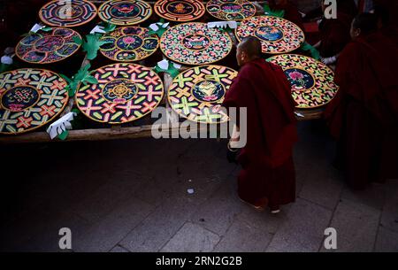 (150305) -- XINING, March 5, 2015 -- Monks looks at ghee flower artworks at Taer Monastery in Xining, northwest China s Qinghai Province, March 5, 2015. Ghee flower exhibitions are held in Taer Monastery in Qinghai Province and Labrang Monastery in Gansu Province, both presitigious Tibetan Buddhist monasteries, to celebrate the Lantern Festival on March 5. ) (zkr) CHINA-QINGHAI-GANSU-GHEE FLOWER-EXHIBITIONS (CN) ZhangxHongxiang PUBLICATIONxNOTxINxCHN   Xining March 5 2015 Monks Looks AT Ghee Flower Artworks AT Taer monastery in Xining Northwest China S Qinghai Province March 5 2015 Ghee Flower Stock Photo