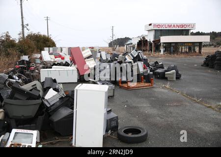 (150310) -- FUKUSHIMA, March 10, 2015 -- Abandoned houses and wastes are seen in the Futaba District, located well within the 20-kilometer exclusion radius around the leaking facilities of Fukushima Daiichi nuclear power plant, in Fukushima Prefecture, Japan, March 7, 2015. The scenes from the towns and villages still abandoned four years after an earthquake triggered tsunami breached the defenses of the Fukushima Daiichi nuclear power plant, would make for the perfect backdrop for a post- apocalyptic Hollywood zombie movie, but the trouble would be that the levels of radiation in the area wou Stock Photo