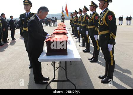 Chinese Ambassador to South Korea Qiu Guohong covers caskets containing ...