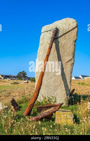 France, Morbihan, Hoedic island, old rusty anchor and menhir at the entrance to the village Stock Photo