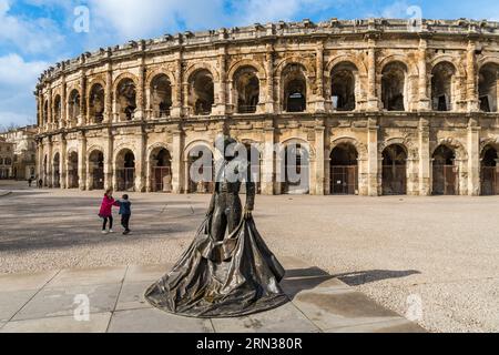 France, Gard, Nimes, Place des Arènes, statue of the bullfighter Nimeno II by Serena Carone from 1994 in front of the Arena Stock Photo