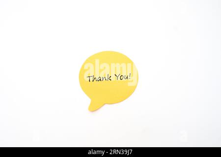 Yellow Post it Note Speech Bubble with Hand Written Thank You Text Stock Photo