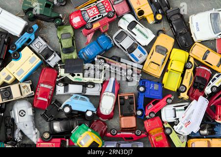 View Looking Down On A Collection Of Plastic, Metal, Dinky, Corgi Toy Cars Displayed On The Floor, UK Stock Photo