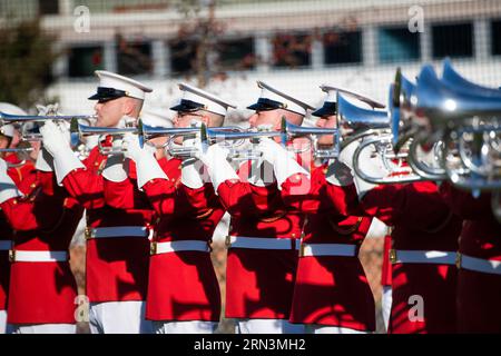 US Marine Corps Commandants Own Drum Bugle Corps Arlington Virginia | ARLINGTON, Virginia, United States — Bugle players of the US Marine Corps Commandant's Own march in tight formation during an outdoor school performance in Arlington. The corps, one of only a handful of all-bugle ensembles in the world, plays valved bugles pitched in G, a brass tradition distinct from the B-flat trumpet and rooted in Continental Army field music. Stock Photo