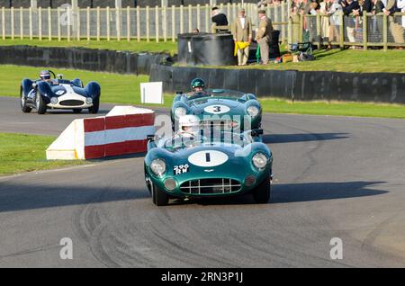 Aston Martin DBR1/1 classic sports car, vintage racing car competing in the Sussex Trophy at the Goodwood Revival historic event, UK. Cars chasing Stock Photo