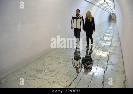 (150425) -- KONJIC, Bosnia and Herzegovina, April 24, 2015 -- Two visitors walk on a work of art at the 3rd cycle of the international project Biennial of Contemporary Art DO ARK Underground in Konjic, Bosnia-Herzegovina, on April 24, 2015. The exhibition opened Friday in the biggest nuclear bunker in ex-Yugoslavia, which was constructed in 1979. ) BOSNIA AND HERZEGOVINA-KONJIC-ART-NUCLEAR BUNKER HarisxMemija PUBLICATIONxNOTxINxCHN   Konjic Bosnia and Herzegovina April 24 2015 Two Visitors Walk ON a Work of Art AT The 3rd Cycle of The International Project Biennial of Contemporary Art Do Ark U Stock Photo