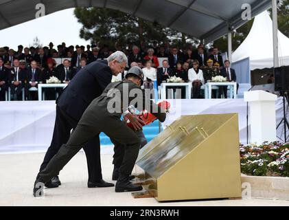 Turkish Minister for EU Affairs Volkan Bozkir(L) presents a bouquet at Turkish memorial service in Canakkale, Turkey, April 25, 2015. Leaders and dignitaries from the UK, Ireland, Australia and New Zealand joined Turkish military delegates to attend Turkish memorial service on Saturday at the 57th Infantry Regiment Memorial, as an event of 100th anniversary of the Gallipoli Battle. ) TURKEY-CANAKKALE-TURKISH MEMORIAL SERVICE HexCanling PUBLICATIONxNOTxINxCHN   Turkish Ministers for EU Affairs Volkan BOZKIR l Presents a Bouquet AT Turkish Memorial Service in Canakkale Turkey April 25 2015 Leade Stock Photo