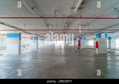 An empty parking garage stands as a cavernous space, waiting to welcome vehicles and providing ample room for convenience and organization. Stock Photo