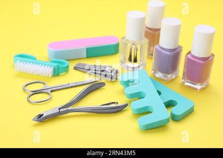 Set of pedicure tools on yellow background Stock Photo
