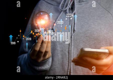 Planning and strategy in the stock market business progress or success Businessman or trader touching hands showing virtual holographic stocks, invest Stock Photo