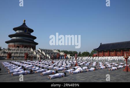 (150515) -- BEIJING, May 15, 2015 -- People practise Yoga during a Taichi and Yoga show at the Temple of Heaven in Beijing, capital of China, May 15, 2015. The show is held to promote the cultural exchange between China and India. ) (zkr) CHINA-BEIJING-TAICHI AND YOGA SHOW(CN) PangxXinglei PUBLICATIONxNOTxINxCHN   Beijing May 15 2015 Celebrities practice Yoga during a Tai Chi and Yoga Show AT The Temple of Heaven in Beijing Capital of China May 15 2015 The Show IS Hero to promote The Cultural Exchange between China and India CCR China Beijing Tai Chi and Yoga Show CN PangxXinglei PUBLICATIONxN Stock Photo
