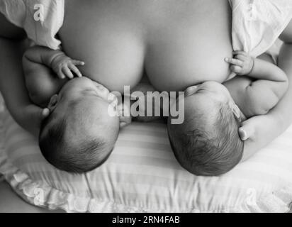 (150520) -- BEIJING, May 20, 2015 -- Photo provided by La Leche League-China shows a mother breastfeeding her children. May 20 is China s National Breastfeeding Awareness Day. As the pronounciation of 520 is close to I Love You, many mothers feel meaningful to have their breastfeeding photos to make public. La Leche League-China, a branch of an international organization that provides mother-to-mother support, information and encouragment for breastfeeding, has collected art photos of breastfeeding mothers for three consecutive years. () (lfj) CHINA-BREASTFEEDING DAY-ART PHOTOS (CN) Xinhua/Lax Stock Photo