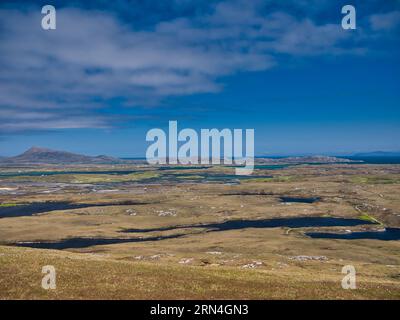 The coast of East Benbecula in the Outer Hebrides, Scotland, UK looking toward the island of North Uist. The Isle of Skye appears in the far distance Stock Photo