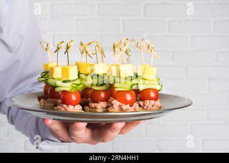 Chef holding plate with catering food Stock Photo