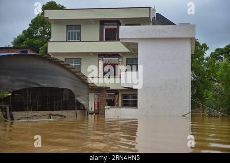 (150521) -- NANCHANG, May 21, 2015 -- Villagers are seen in a house surrounded by flood water in Chexi Town of east China s Jiangxi Province, May 21, 2015. The National Commission for Disaster Reduction launched an emergency response on Thursday to aid east China s flooded Jiangxi Province. As of Thursday morning, heavy rain and flooding have affected a total of 969,000 people and damaged about 8,836 houses in Jiangxi, leaving 8 people dead and 3 missing, according to the local government. ) (zhs) CHINA-JIANGXI-FLOOD (CN) ZhouxMi PUBLICATIONxNOTxINxCHN   150521 Nanchang May 21 2015 Villagers a Stock Photo