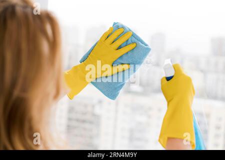 Woman cleaning window with rag Stock Photo