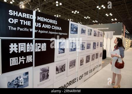 (150528) -- NEW YORK, May 28, 2015 -- A visitor looks at photos at Shared Memories of the US and China photo exhibition during the BookExpo America (BEA) 2015 in New York, the United States, on May 28, 2015. A book launch and a photo exhibition of the Shared Memories of the US and China in fighting side by side in the Second World War were held on Thursday as part of the ongoing BookExpo America (BEA) 2015. ) US-NEW YORK-WWII-MEMORIES-BOOK-PHOTO EXHIBITION LixMuzi PUBLICATIONxNOTxINxCHN   150528 New York May 28 2015 a Visitor Looks AT Photos AT Shared Memories of The U.S. and China Photo Exhib Stock Photo