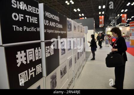 (150528) -- NEW YORK, May 28, 2015 -- Visitors look at photos at Shared Memories of the US and China photo exhibition during the BookExpo America (BEA) 2015 in New York, the United States, on May 28, 2015. A book launch and a photo exhibition of the Shared Memories of the US and China in fighting side by side in the Second World War were held on Thursday as part of the ongoing BookExpo America (BEA) 2015. ) US-NEW YORK-WWII-MEMORIES-BOOK-PHOTO EXHIBITION WangxLei PUBLICATIONxNOTxINxCHN   150528 New York May 28 2015 Visitors Look AT Photos AT Shared Memories of The U.S. and China Photo Exhibiti Stock Photo