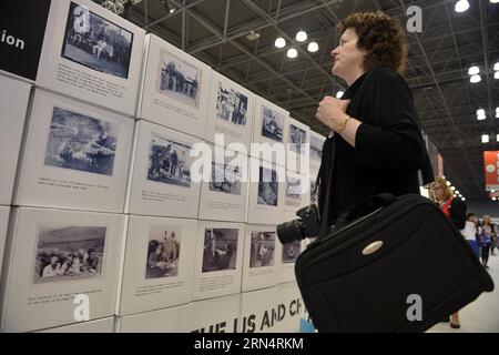 (150528) -- NEW YORK, May 28, 2015 -- A woman looks at photos at Shared Memories of the US and China photo exhibition during the BookExpo America (BEA) 2015 in New York, the United States, on May 28, 2015. A book launch and a photo exhibition of the Shared Memories of the US and China in fighting side by side in the Second World War were held on Thursday as part of the ongoing BookExpo America (BEA) 2015. ) US-NEW YORK-WWII-MEMORIES-BOOK-PHOTO EXHIBITION WangxLei PUBLICATIONxNOTxINxCHN   150528 New York May 28 2015 a Woman Looks AT Photos AT Shared Memories of The U.S. and China Photo Exhibiti Stock Photo