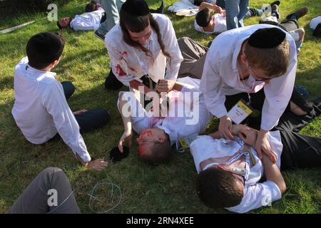 Injured Israeli tennagers are rescued during a rocket attack simulation in Kibbutz Mevo Horon, on June 2, 2015. Sirens were heard across Israel Tuesday morning as part of a nationwide military drill simulating three-front missile attack. According to a statement by the Home Front Command, the week-long drill focused on checking the preparedness of the Israeli home-front in case of simultaneous rocket barrages from the Gaza Strip, Lebanon and Syria. ) MIDEAST-KIBBUTZ MEVO HORON-ROCKET ATTACK SIMULATION GilxCohenxMagen PUBLICATIONxNOTxINxCHN   Injured Israeli  are Rescued during a Rocket Attack Stock Photo