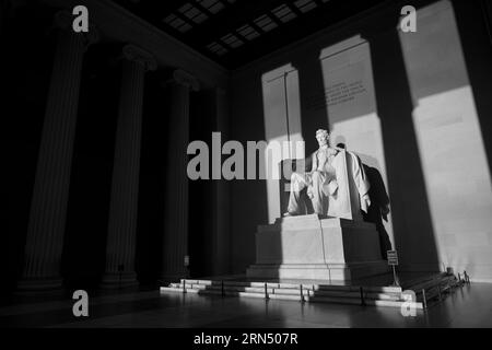 WASHINGTON, DC - The Lincoln Memorial sits on the western end of Washington DC's National Mall. It faces directly east towards the Washington Monument and US Capitol Building. Styled in the form of a neoclassical temple, its main chamber is dominated by a large statue of a seated President Abraham Lincoln. It was designed by Daniel Chester French and completed in 1920. The Lincoln Memorial was dedicated in May 1922. Stock Photo