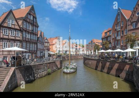 Historic merchant and warehouse houses at the Hanseatic harbour with the sailing ship Willi, Old Town, Stade, Lower Saxony, Germany Stock Photo