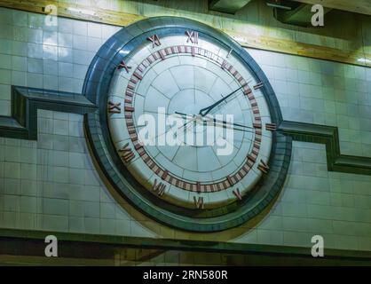 Large wall mounted clock above tunnel in Seattle Westlake station on route to airport Stock Photo