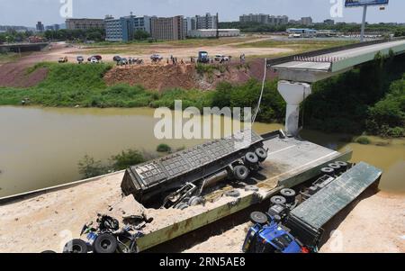 HEYUAN, June 19, 2015 -- Heavy trucks fall under a highway after a ramp of the Guangdong-Jiangxi Highway collapses in Heyuan, south China s Guangdong Province, June 19, 2015. The accident, which killed one person and injured four others, happened at 3:40 a.m. on June 19 (1940 GMT on June 18) in Heyuan City when a bridge ruptured with four heavy trucks loaded with porcelain clay on it, according to an investigation. The highway, opened to traffic in December of 2005, connects Guangdong with east China s Jiangxi Province. ) (lfj) CHINA-GUANGDONG-HIGHWAY RAMP-COLLAPSE (CN) LuxHanxin PUBLICATIONxN Stock Photo