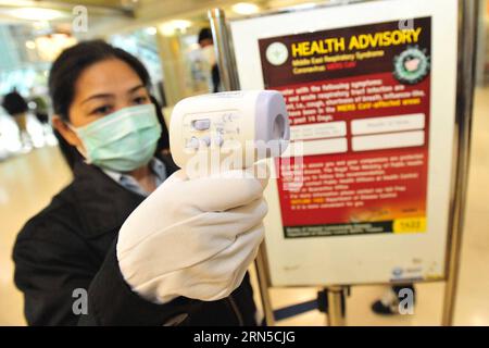 (150621) -- BANGKOK, June 21, 2015 -- An officer holding a digital thermometer checks people s body temperature at Suvarnabhumi Airport in Bangkok, Thailand, June 21, 2015. Thailand s public health ministry on Thursday confirmed the country s first case of the Middle East Respiratory Syndrome (MERS). Citizens and travellers have begun to undertake preventive methods such as wearing protective facial masks in Bangkok. ) THAILAND-BANGKOK-MERS RachenxSageamsak PUBLICATIONxNOTxINxCHN   150621 Bangkok June 21 2015 to Officer Holding a Digital Thermometer Checks Celebrities S Body temperature AT Suv Stock Photo