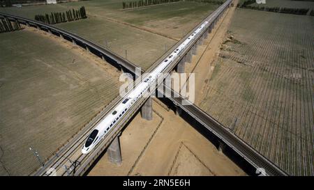 (150623) -- URUMQI, June 23, 2015 -- Photo taken with a drone on May 21, 2015 shows a bullet train runs on the railway linking Hami to Lop Nor, northwest China s Xinjiang Uygur Autonomous Region. The 1,776-kilometer Lanxin high-speed railway was put into operation on Dec. 26, 2014, linking Lanzhou, capital of Gansu Province, Xining, capital of Qinghai Province, and Urumqi, all in northwest China. In 2015, aerial photos of the Xinjiang section of Lanxin high-speed railway were taken by an aerial photography group of Xinhua News Agency and various landforms of Xinjiang have been recorded. (p) CH Stock Photo