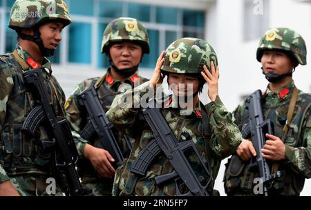 DEHONG, June 24, 2015 -- Zhang Liu talks with her comrades at the border checkpoint of Mukang in Dehong Dai-Jingpo Autonomous Prefecture, southwest China s Yunnan Province, June 24, 2015. Born in 1995, Zhang Liu became an anti-drug soldier in border checkpoint of Mukang in 2013. Grown up in an affluent family in central China s Hunan Province, Zhang said that being a soldier had always been her dream, which drove her to join the army after graduating from high school. Being a front line anti-drug force, the border checkpoint of Mukang has captured about 100 kilograms of drugs since the beginni Stock Photo