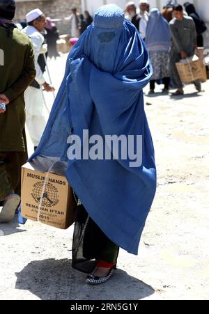 (150625) -- KABUL, June 25, 2015 -- An Afghan woman carries food donated by Muslim Hands International organization for poor people during the holy month of Ramadan in Kabul, Afghanistan, June 25, 2015. ) AFGHANISTAN-KABUL-RAMADAN-FOOD-DISTRIBUTION AhmadxMassoud PUBLICATIONxNOTxINxCHN   150625 Kabul June 25 2015 to Afghan Woman carries Food Donated by Muslim Hands International Organization for Poor Celebrities during The Holy Month of Ramadan in Kabul Afghanistan June 25 2015 Afghanistan Kabul Ramadan Food Distribution AhmadxMassoud PUBLICATIONxNOTxINxCHN Stock Photo