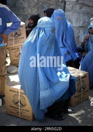 (150625) -- KABUL, June 25, 2015 -- Afghan women wait for transportation after receving food donated by Muslim Hands International organization for poor people during the holy month of Ramadan in Kabul, Afghanistan, June 25, 2015. ) AFGHANISTAN-KABUL-RAMADAN-FOOD-DISTRIBUTION AhmadxMassoud PUBLICATIONxNOTxINxCHN   150625 Kabul June 25 2015 Afghan Women Wait for Transportation After receving Food Donated by Muslim Hands International Organization for Poor Celebrities during The Holy Month of Ramadan in Kabul Afghanistan June 25 2015 Afghanistan Kabul Ramadan Food Distribution AhmadxMassoud PUBL Stock Photo