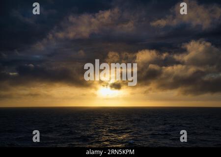 Atmospheric sunset with dramatic clouds over the North Sea, Netherlands Stock Photo